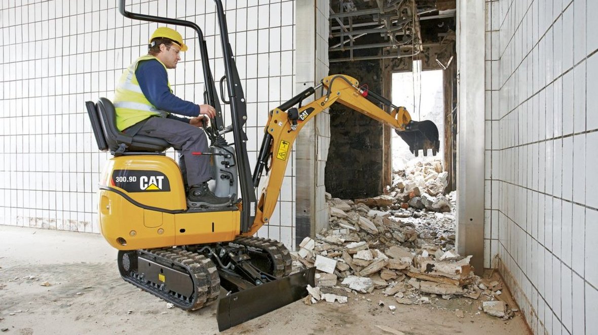 Caterpillar 300.9D ze zwartą konstrukcją